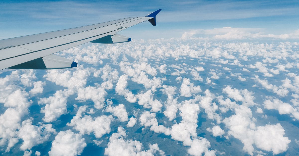 How fast is the free Wi-Fi at Kiev airport? - Aerial view of modern metal airplane wing in blue sky over fluffy clouds How fast is the free Wi-Fi at Kiev airport? - Aerial view of modern metal airplane wing in blue sky over fluffy clouds