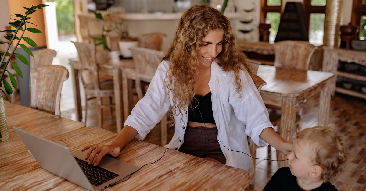How hard is finding a job as a part-time software developer on a working holiday speaking English in a Nordic country? [closed] - Photo of Woman Smiling While Sitting by the Table With Her Child