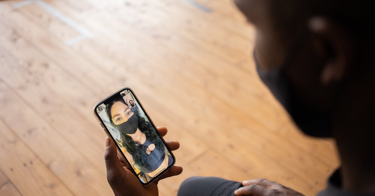 How is Venice during COVID times? - Crop black man talking to girlfriend in mask on smartphone How is Venice during COVID times? - Crop black man talking to girlfriend in mask on smartphone
