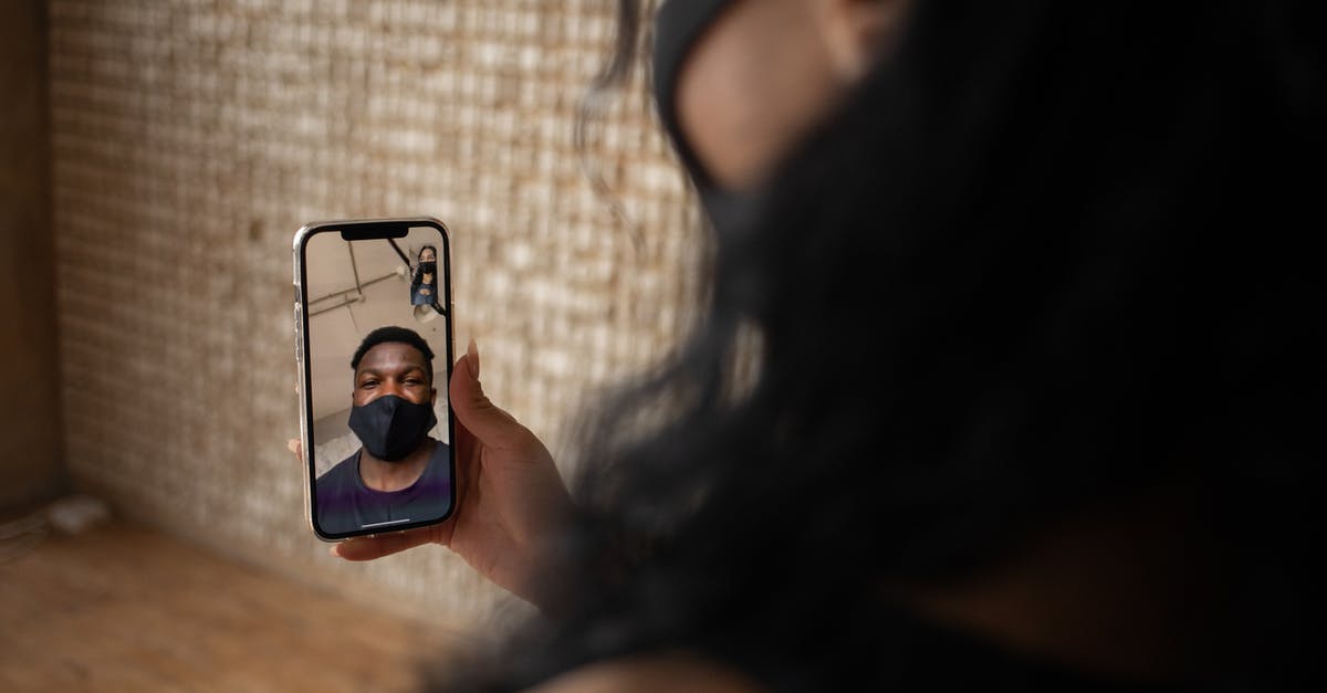 How is Venice during COVID times? - Back view of crop anonymous female talking to ethnic male beloved in fabric mask during video call on cellphone How is Venice during COVID times? - Back view of crop anonymous female talking to ethnic male beloved in fabric mask during video call on cellphone