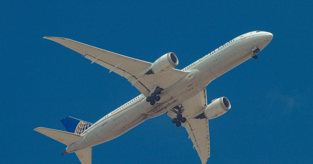 How long do I need from landing in Zurich to get to a connecting flight to Dublin? - From below of aircraft for transporting passengers with landing gear prepared for landing on blue sky