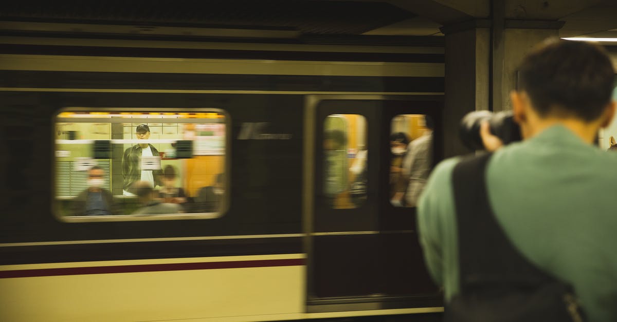 How long does it take to get a transit visa to travel through Canada? - Photographer with modern device taking photo of train with passengers How long does it take to get a transit visa to travel through Canada? - Photographer with modern device taking photo of train with passengers