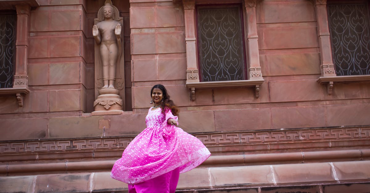 How long does my Indian visa need to be active after I have entered into India? - Full body of happy Indian female in traditional dress smiling and spinning around on street near ancient stone ornamental building
