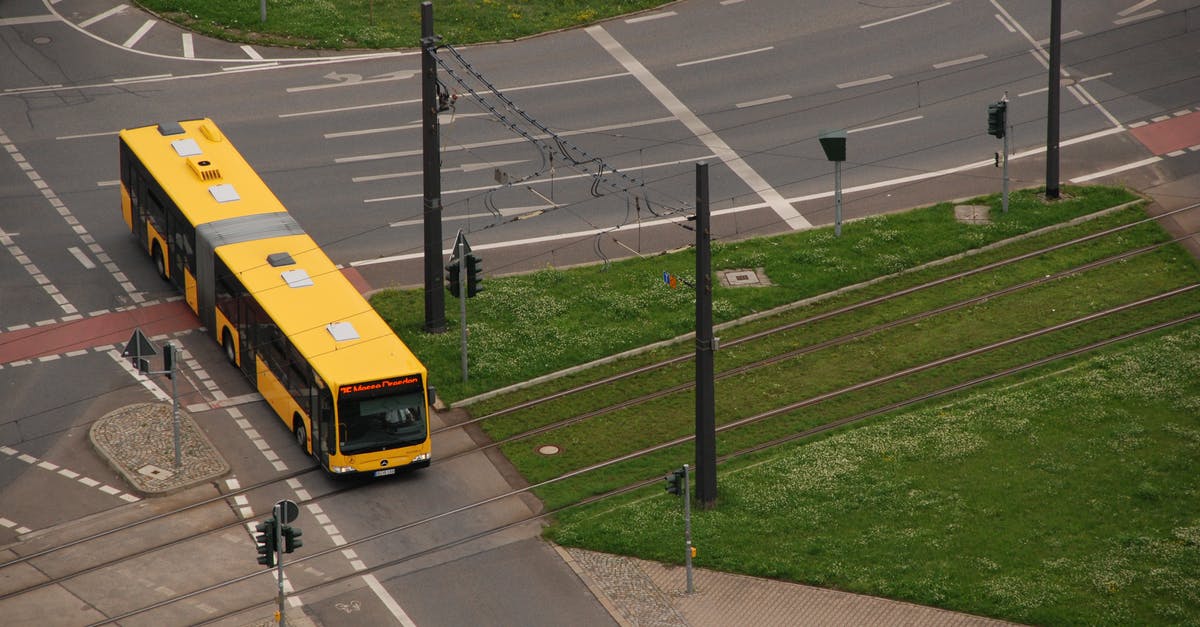 How long does the bus take to go from Viterbo to Orvieto? - A Long Bus Crossing a Railroad