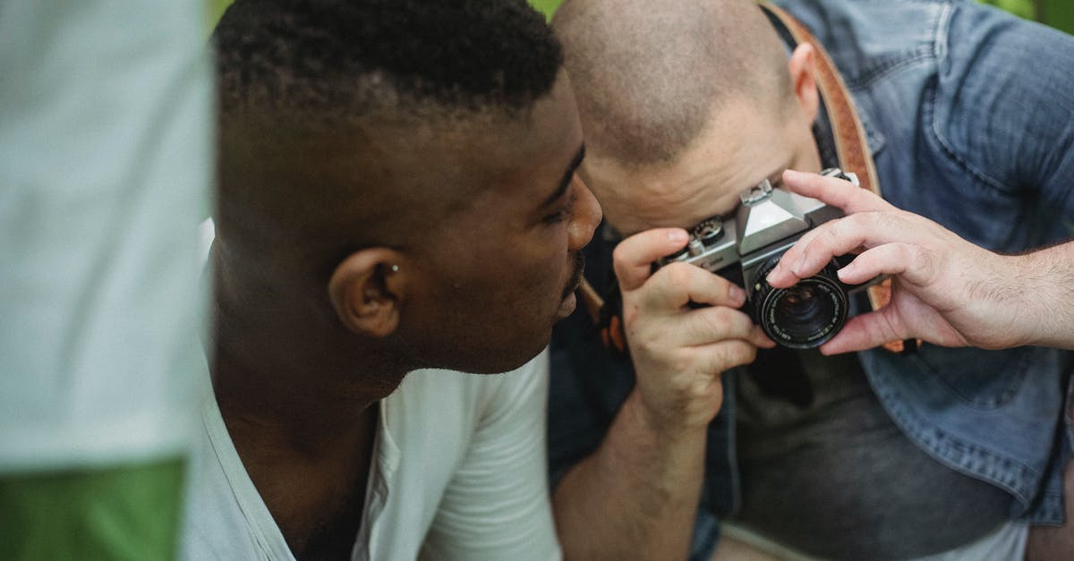 How long would it take to hike from Hamar to Lillehammer? - Man taking photo on camera while hiking with black friend How long would it take to hike from Hamar to Lillehammer? - Man taking photo on camera while hiking with black friend