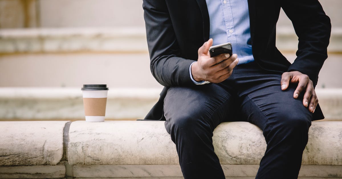 How manageable are <15 min connection times in Frankfurt Hbf? - Crop faceless male manager in formal wear sitting on marble bench and messaging on mobile phone during coffee break How manageable are <15 min connection times in Frankfurt Hbf? - Crop faceless male manager in formal wear sitting on marble bench and messaging on mobile phone during coffee break