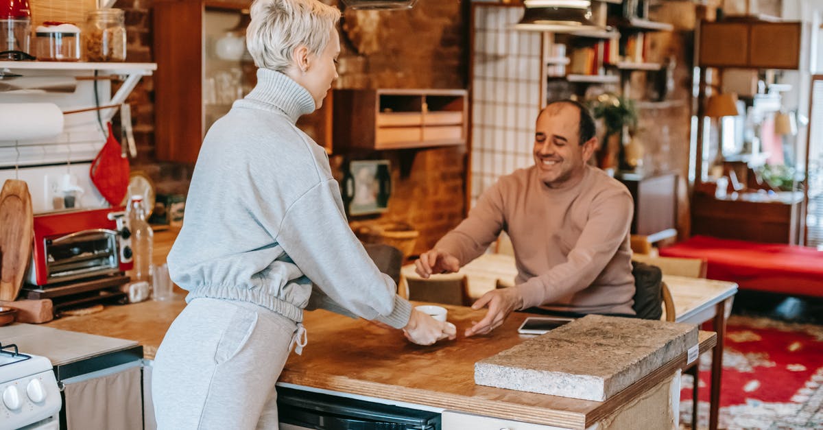 How many boarding pass do i receive if my journey has 2 stops? [closed] - Adult glad man receiving cup of hot beverage from female partner at table in kitchen