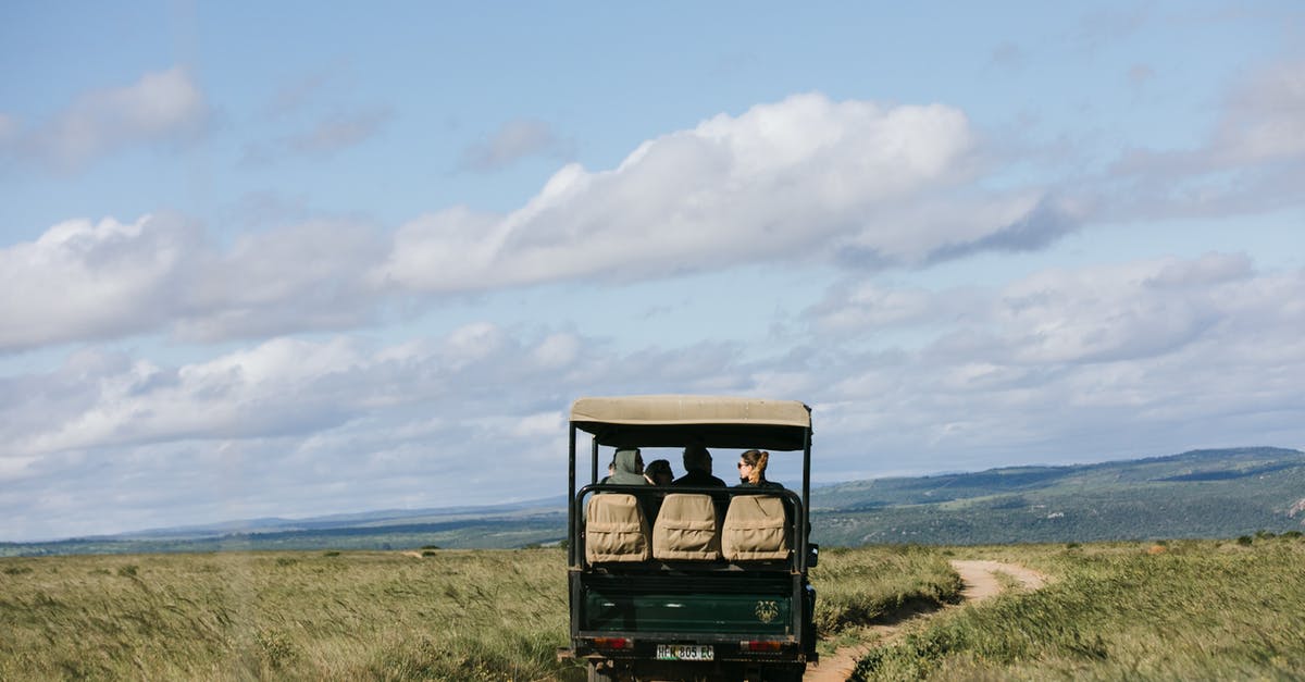 How many km per day in on the road trip to patagonia? [closed] - Faceless tourist riding on car through meadow