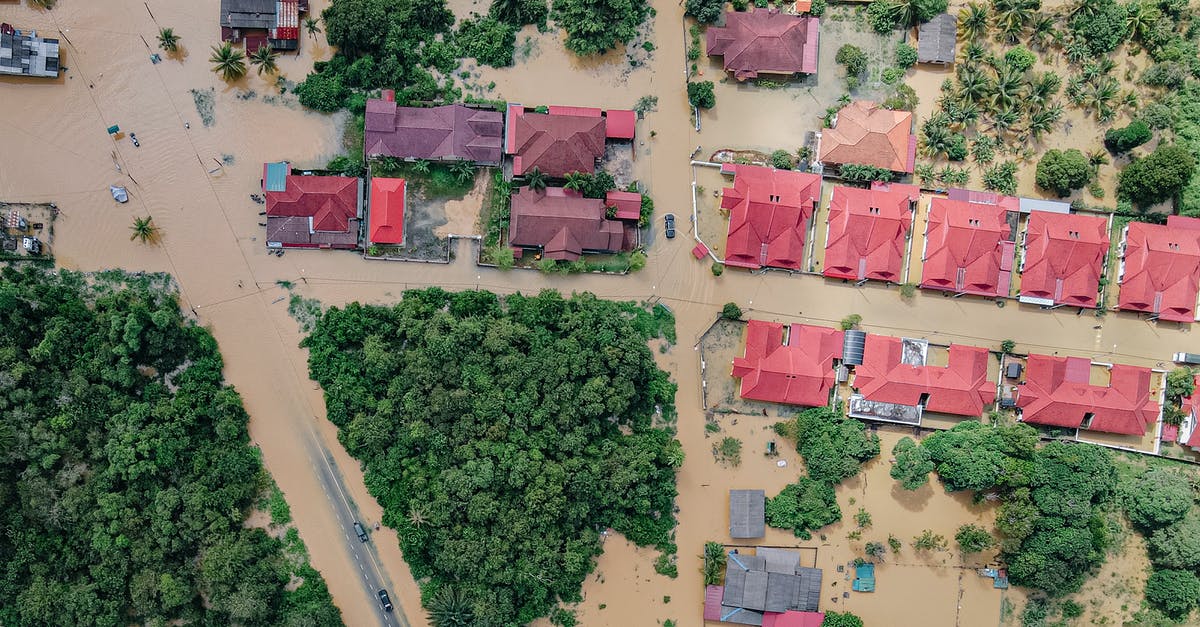 How many years am I banned from entering the Schengen Area? - Overhead view of colorful roofs of residential buildings and lush green trees in flooded small village How many years am I banned from entering the Schengen Area? - Overhead view of colorful roofs of residential buildings and lush green trees in flooded small village