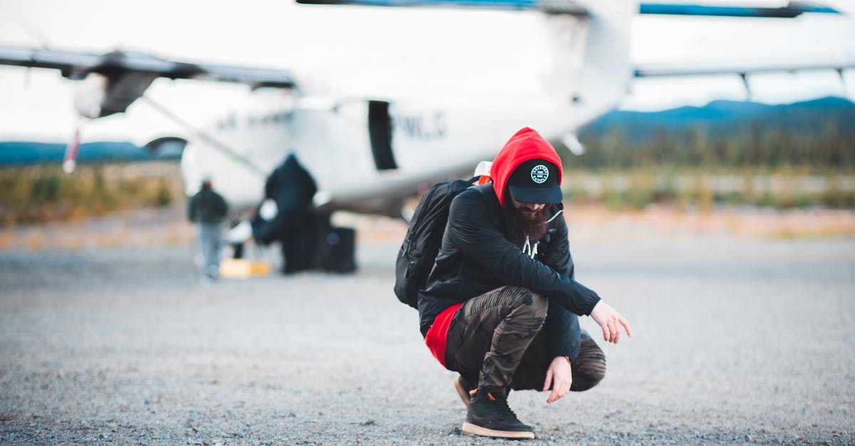 How much should I tip for a private tour in India? - Male backpacker hunkering against contemporary private jet How much should I tip for a private tour in India? - Male backpacker hunkering against contemporary private jet