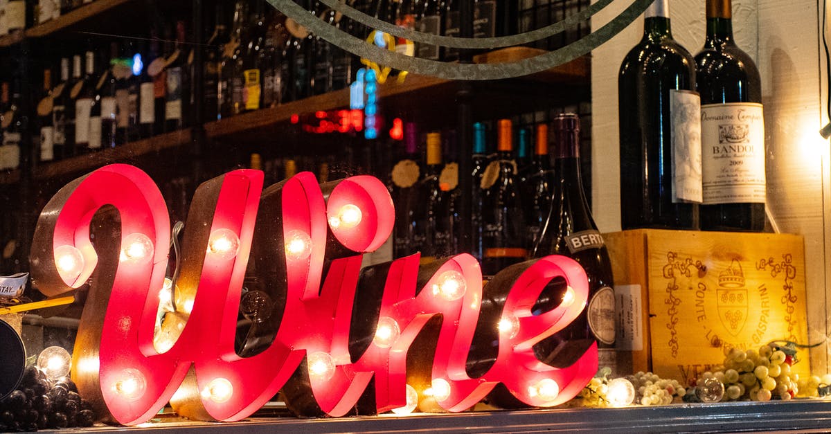 How often do businesses refuse Massachusetts Liquor ID as a proof of age? [closed] - Red Wine Marquee Signage on Table