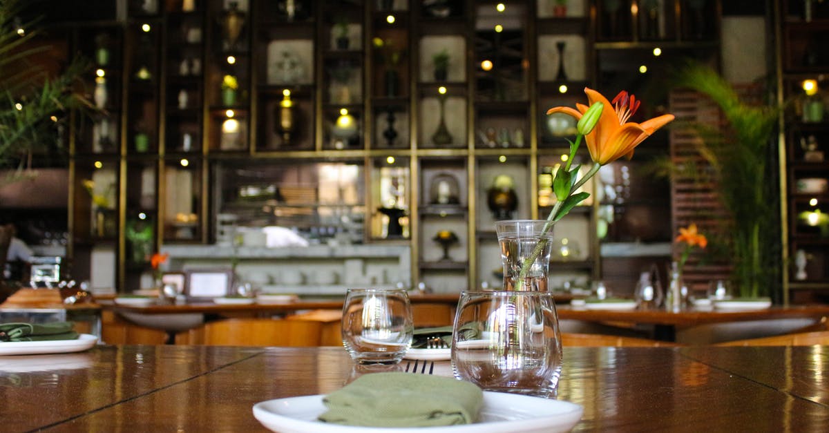 How safe is it to leave my passport in my hotel room? [closed] - Orange Daylily on Clear Glass Pitcher on Brown Wooden Dining Table With Dinnerware
