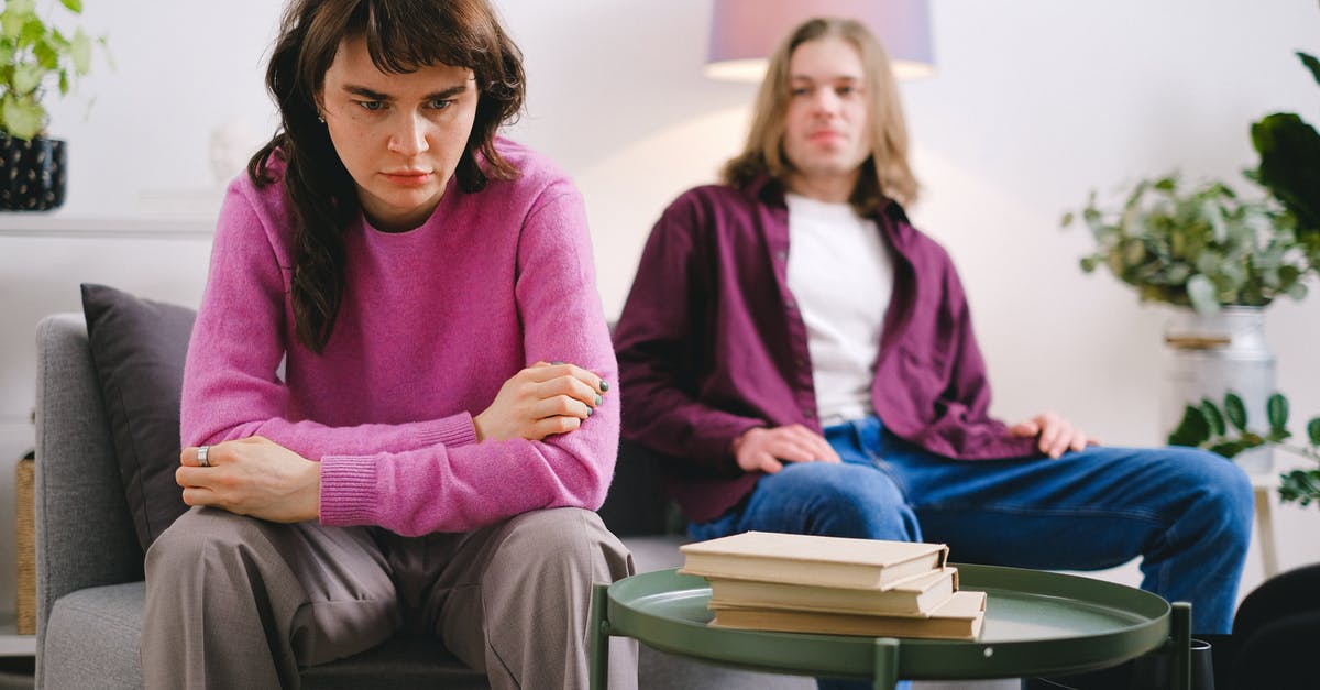 How severe will language problem be in Germany? - Woman in Pink Sweater Sitting Beside Woman in Gray Sweater How severe will language problem be in Germany? - Woman in Pink Sweater Sitting Beside Woman in Gray Sweater