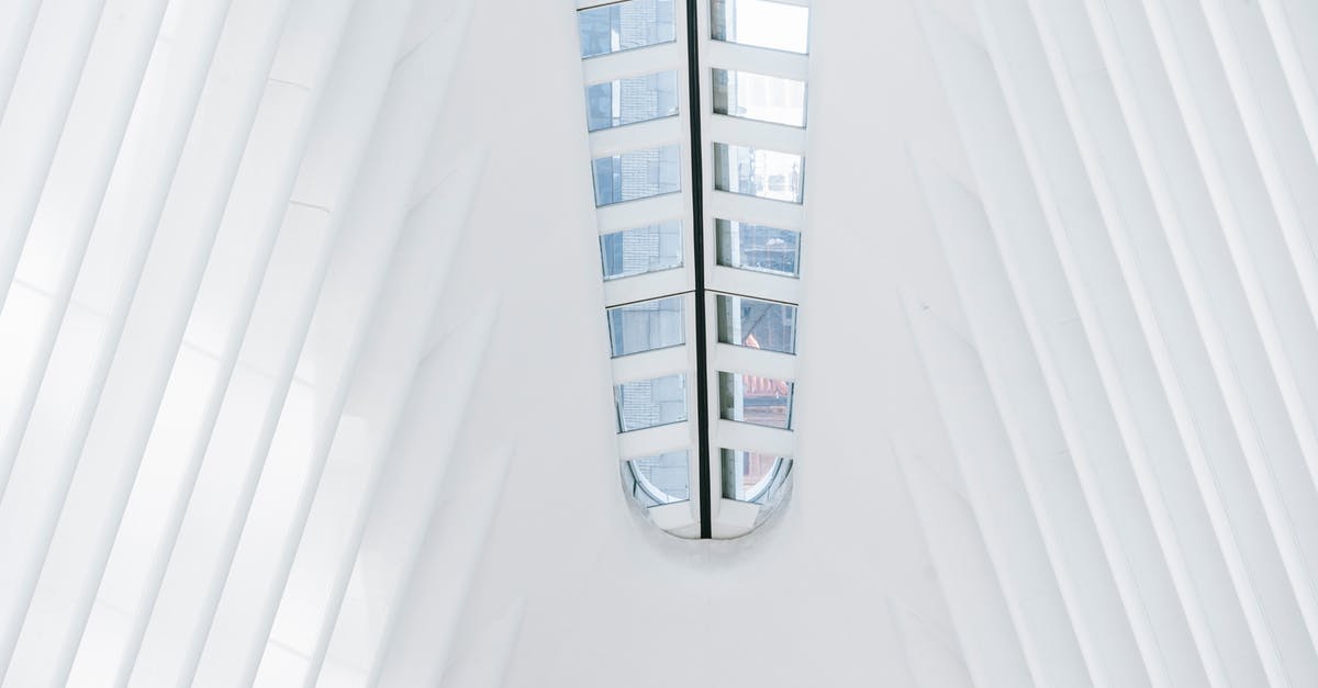 How should a family of five get from DCA American Airlines Terminal to Crystal City Station - From below of geometric white walls of contemporary building with glass windows on ceiling in terminal station on sunny day in New York