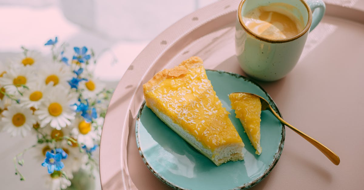 How should I tip if the food is good but the service from the waiter/waitress is terrible in the USA? - From above of delicious latte coffee in ceramic mug and slice of cheese cake on plate served on tray and bunch of field flowers on table