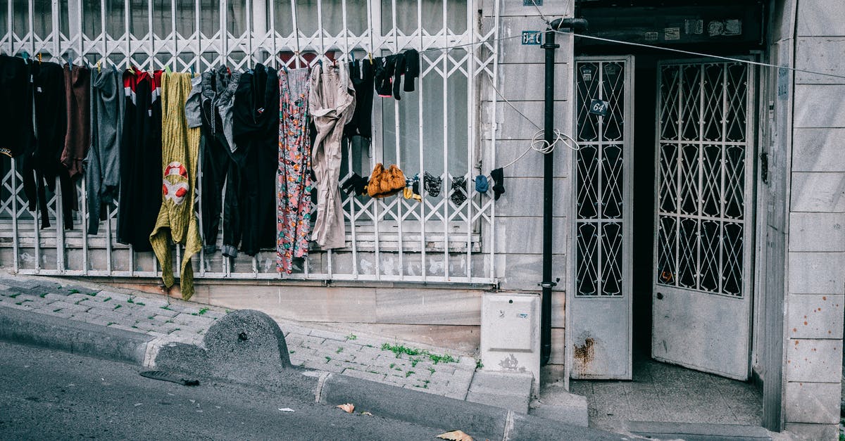 How should I wash clothes in Iceland? - Laundry drying on clothesline near condominium entrance How should I wash clothes in Iceland? - Laundry drying on clothesline near condominium entrance