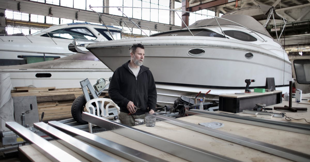 How significant is previous Schengen travel to improve the likelihood of an approval? [closed] - Focused adult worker preparing metal details in workshop with yachts