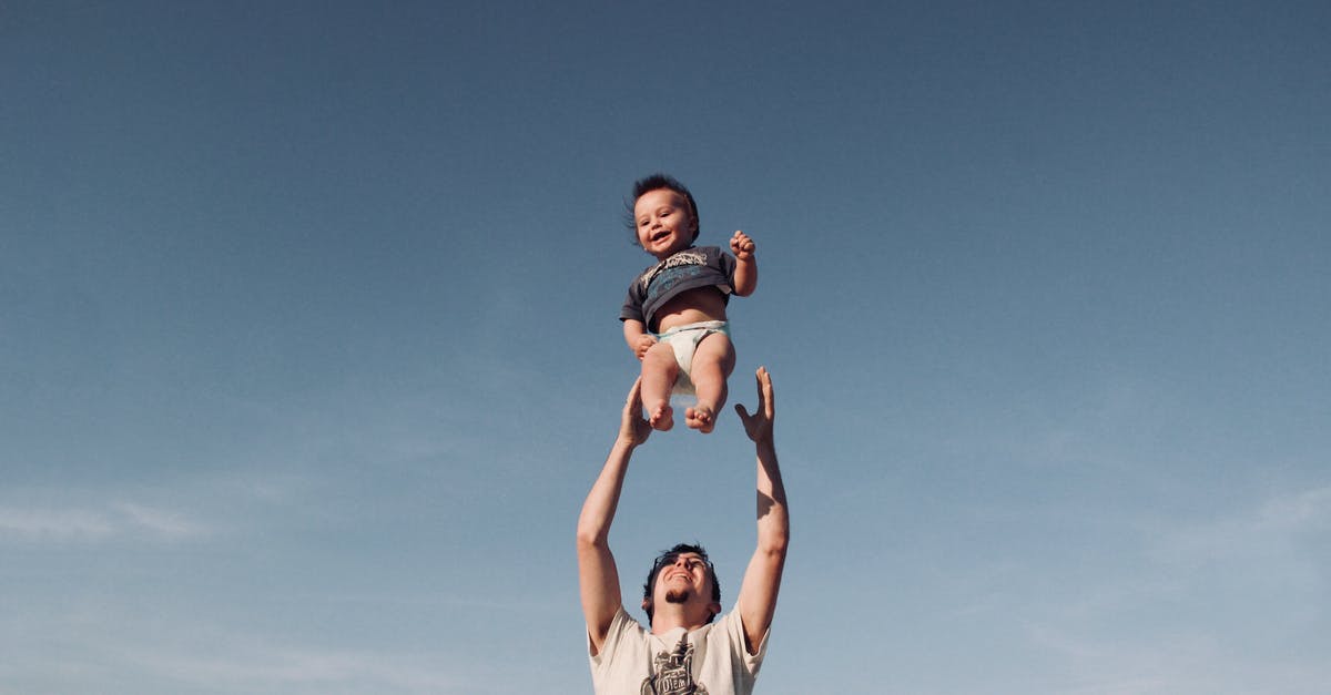 how soon can return to austria to be with my family after being here 90 days [duplicate] - Photo of Man in Raising Baby Under Blue Sky