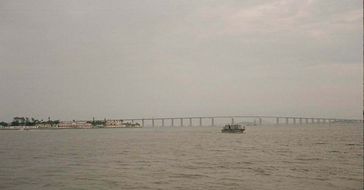 How to access Beausoleil Island for a day trip, without the DayTripper? - Picturesque scene of serene wide river small ship and long bridge in cloudy day