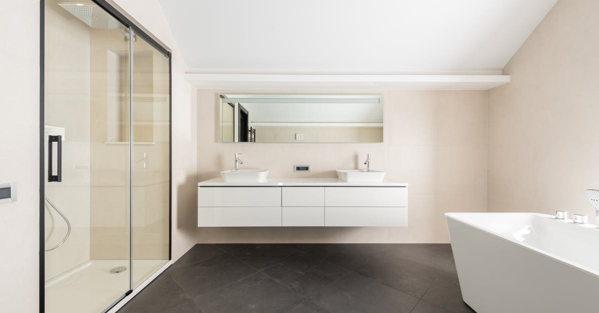 How to adapt to Western Toilets from Indian-style toilets? - Interior of spacious modern bathroom with shower cabin bathtub and minimalist furniture in contemporary apartment How to adapt to Western Toilets from Indian-style toilets? - Interior of spacious modern bathroom with shower cabin bathtub and minimalist furniture in contemporary apartment