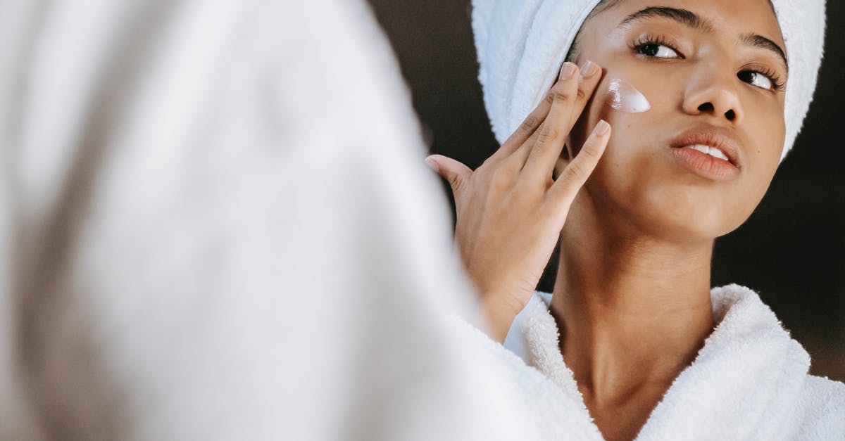 How to apply for a Hong Kong visa from Macao? - Ethnic woman applying cream on face in morning How to apply for a Hong Kong visa from Macao? - Ethnic woman applying cream on face in morning