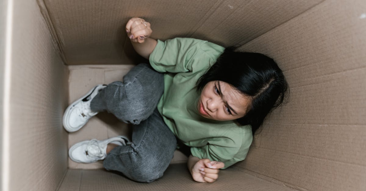 How to avoid claustrophobia on a plane? - A Fearful Woman Having Claustrophobia in a Cardboard Box How to avoid claustrophobia on a plane? - A Fearful Woman Having Claustrophobia in a Cardboard Box
