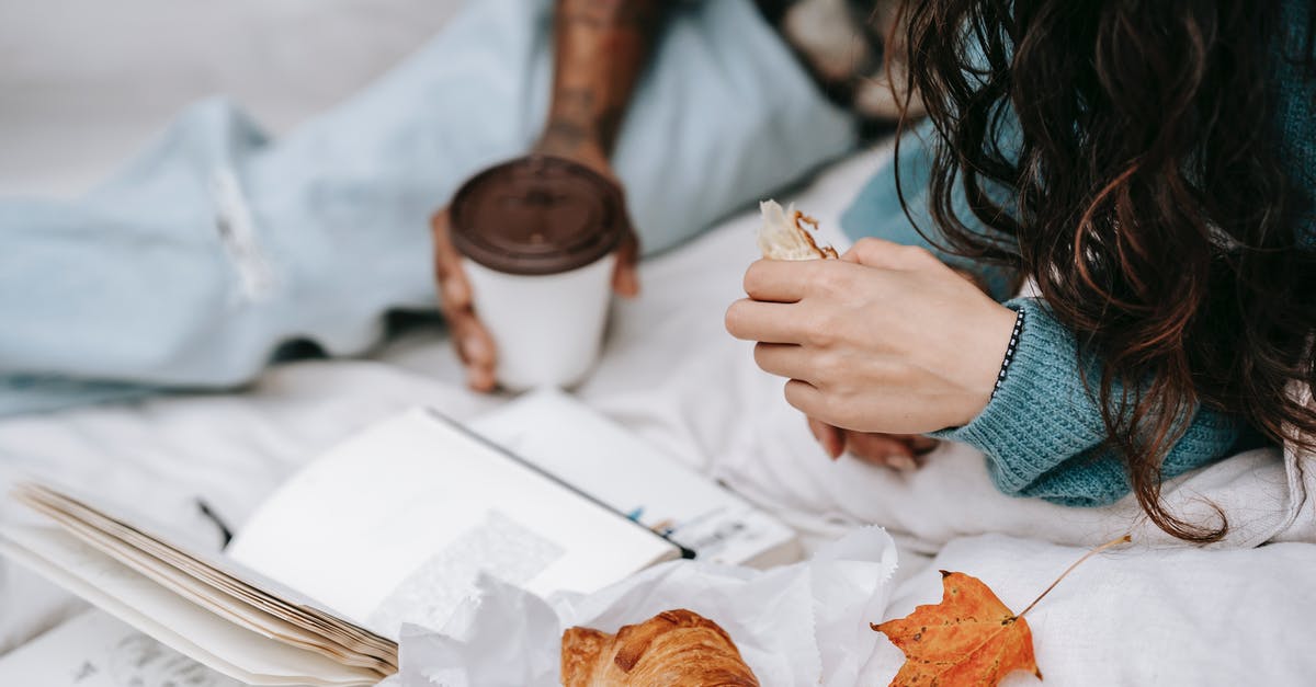 How to book a flight when the exact return date is not known yet? - Unrecognizable multiracial couple with takeaway hot drink and croissant lying on white plaid with opened book during picnic in autumn day
