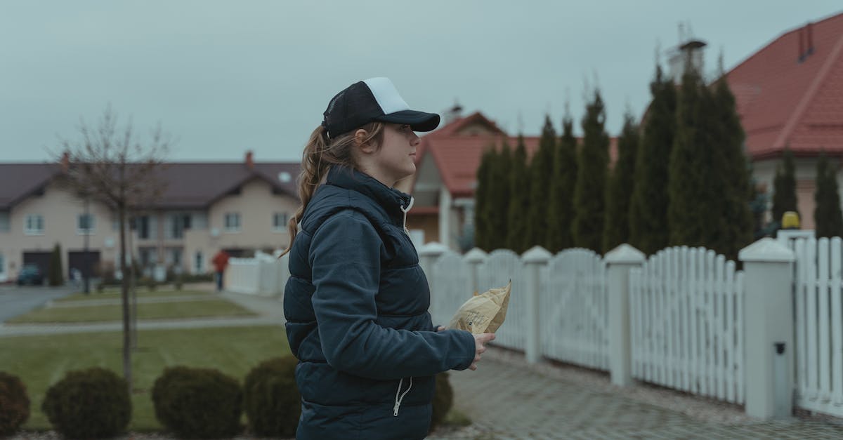 How to book courier flights (discounted fare in exchange for delivering a package upon arrival)? - Woman in Black Jacket Delivering a Parcel