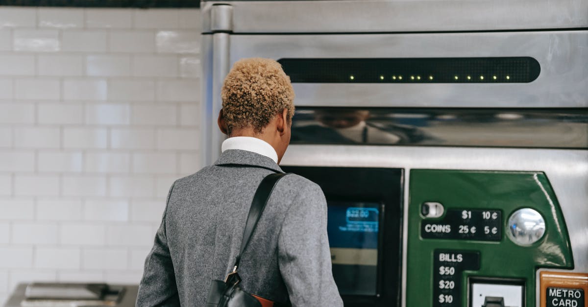 How to buy an Indian railways add-on ticket for a child? - Back view of unrecognizable ethnic female manager with short dyed hair in elegant suit buying ticket with electronic machine in subway station