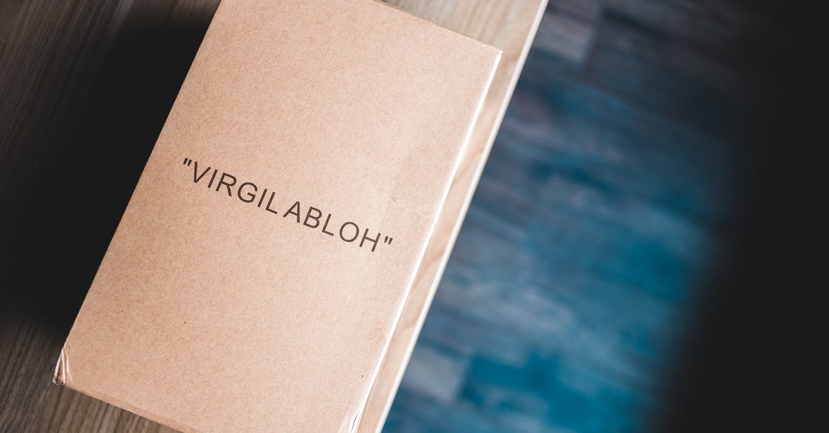 How to buy an international ticket when name on foreign passport is different from name on green card - From above of cardboard box with name on front on wooden table at home How to buy an international ticket when name on foreign passport is different from name on green card - From above of cardboard box with name on front on wooden table at home