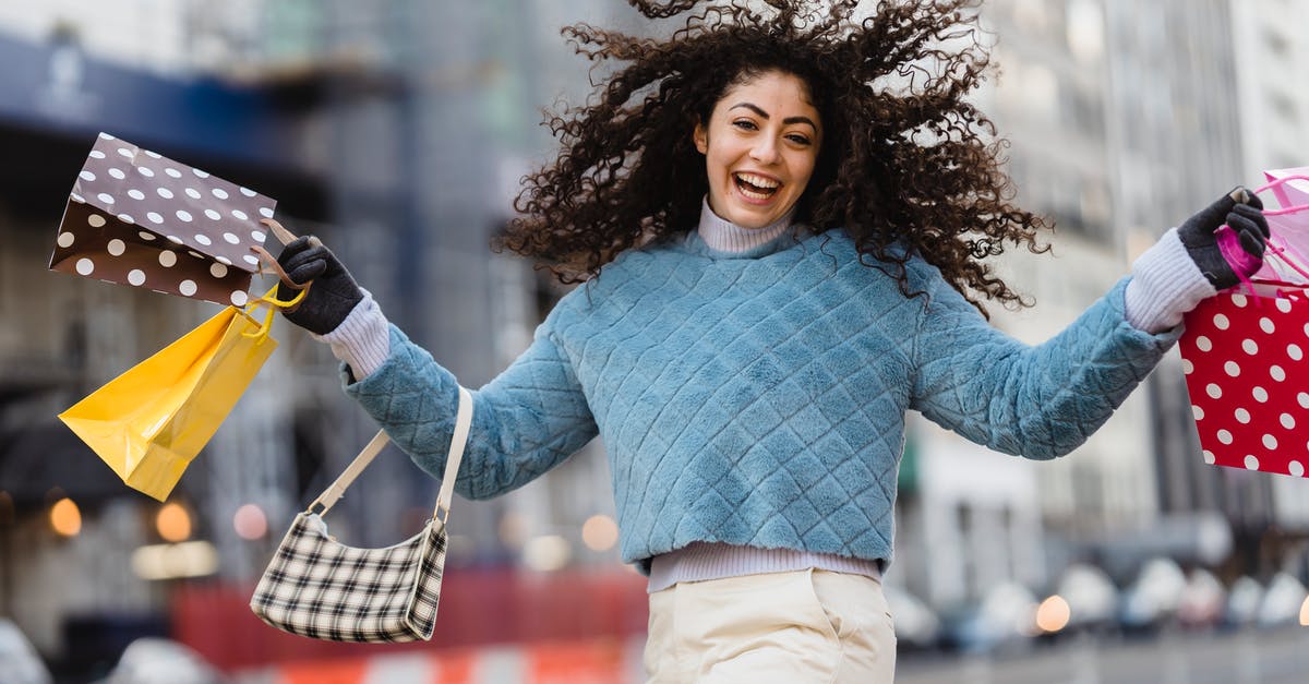 How to buy duty free other than at the airport? - Happy woman jumping with shopping bags How to buy duty free other than at the airport? - Happy woman jumping with shopping bags