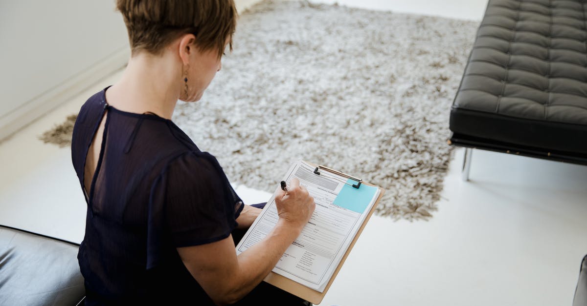How to cancel a DS-160 form - A Woman Holding a Clipboard and Writing How to cancel a DS-160 form - A Woman Holding a Clipboard and Writing