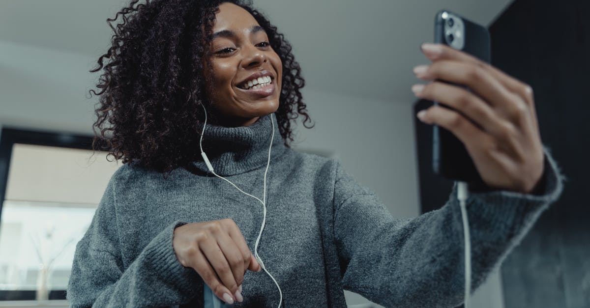 How to cancel an ADO online reservation? - Woman in Gray Sweater Holding Iphone How to cancel an ADO online reservation? - Woman in Gray Sweater Holding Iphone