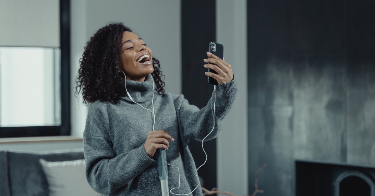 How to cancel an ADO online reservation? - Woman in Gray Sweater Holding Black Smartphone How to cancel an ADO online reservation? - Woman in Gray Sweater Holding Black Smartphone