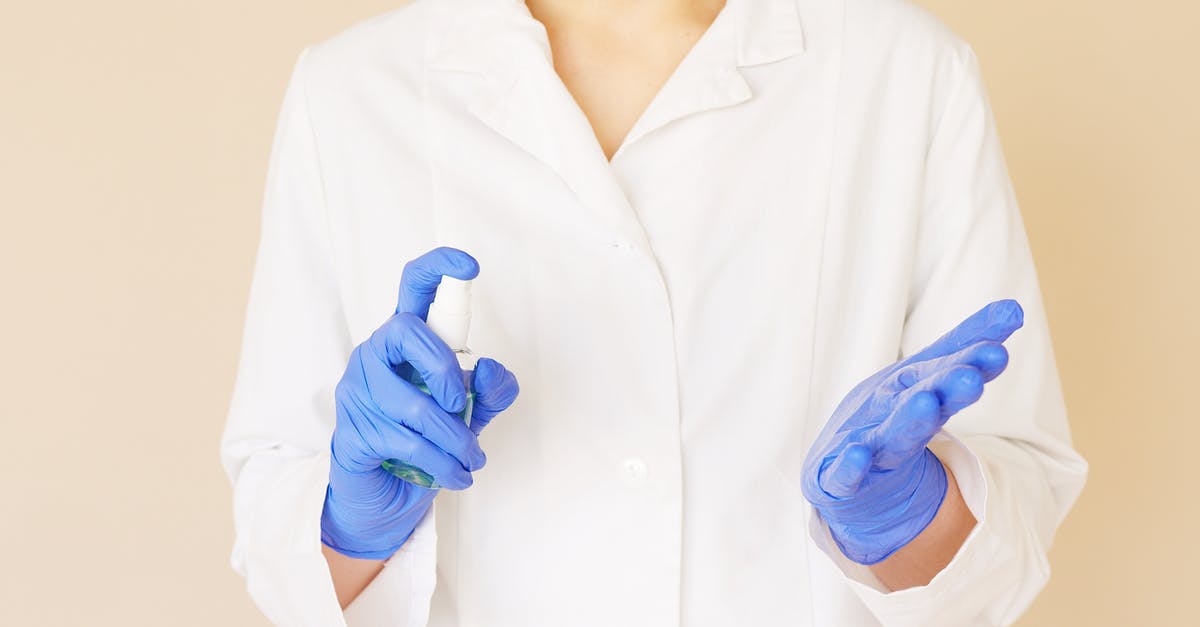 How to carry cologne bottles in hand luggage and prevent losses? - Crop unrecognizable hospital worker in white uniform spraying antiseptic liquid over hands in blue latex gloves How to carry cologne bottles in hand luggage and prevent losses? - Crop unrecognizable hospital worker in white uniform spraying antiseptic liquid over hands in blue latex gloves
