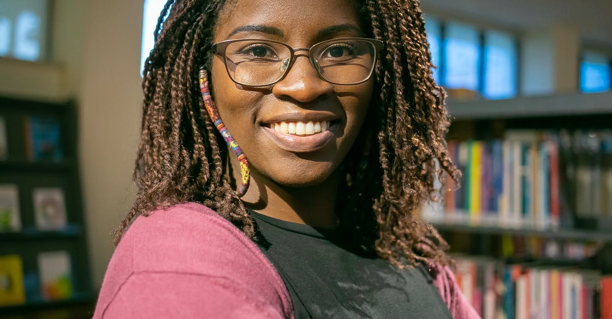 How to choose flights more environmentally friendly based on adding stopovers versus (ultra-)long-haul? [closed] - Cheerful black woman standing in bookstore