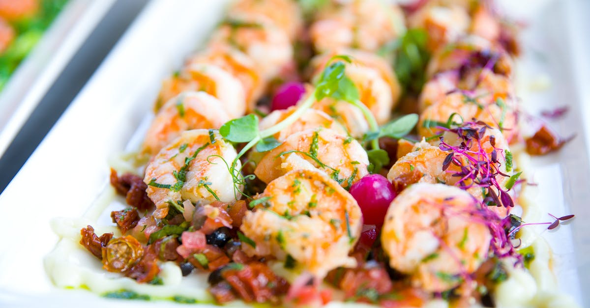 How to claim a refund plus expenses for a changed flight booked through a 3rd party agent [closed] - Closeup of delicious shrimps with vegetables and microgreens on white plate on catering table