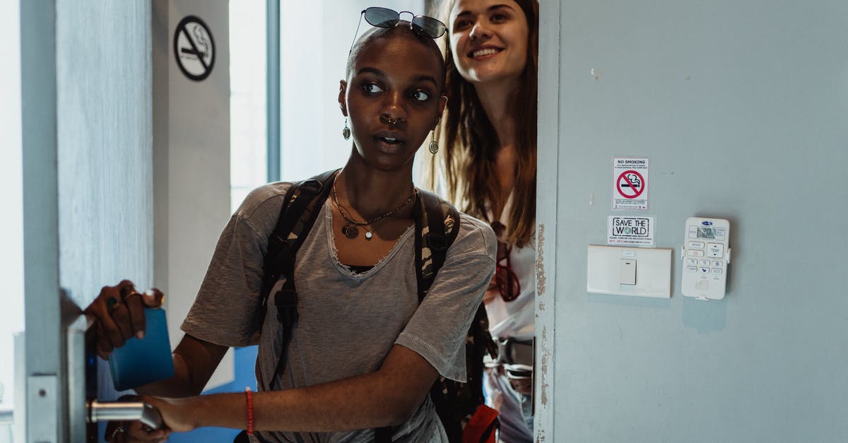 How to determine if a hostel room is a walk-through room? - Women Walking into Their Hostel Room and Smiling 