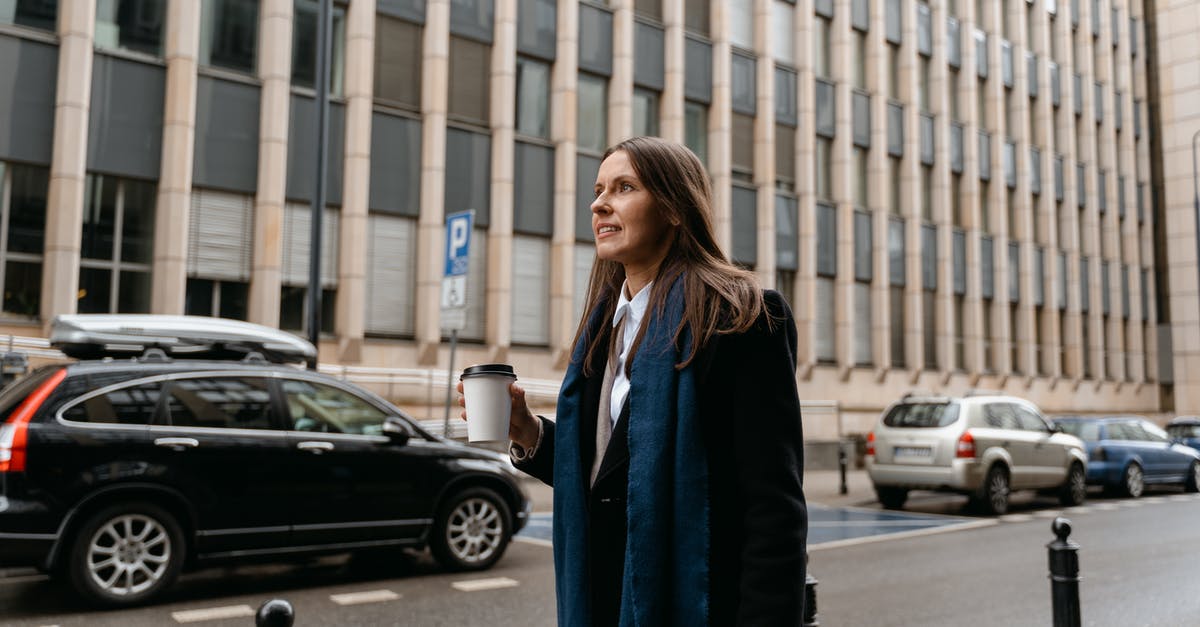 How to divide large bank notes into smaller ones while traveling? - Woman in Black Coat Standing on Sidewalk How to divide large bank notes into smaller ones while traveling? - Woman in Black Coat Standing on Sidewalk