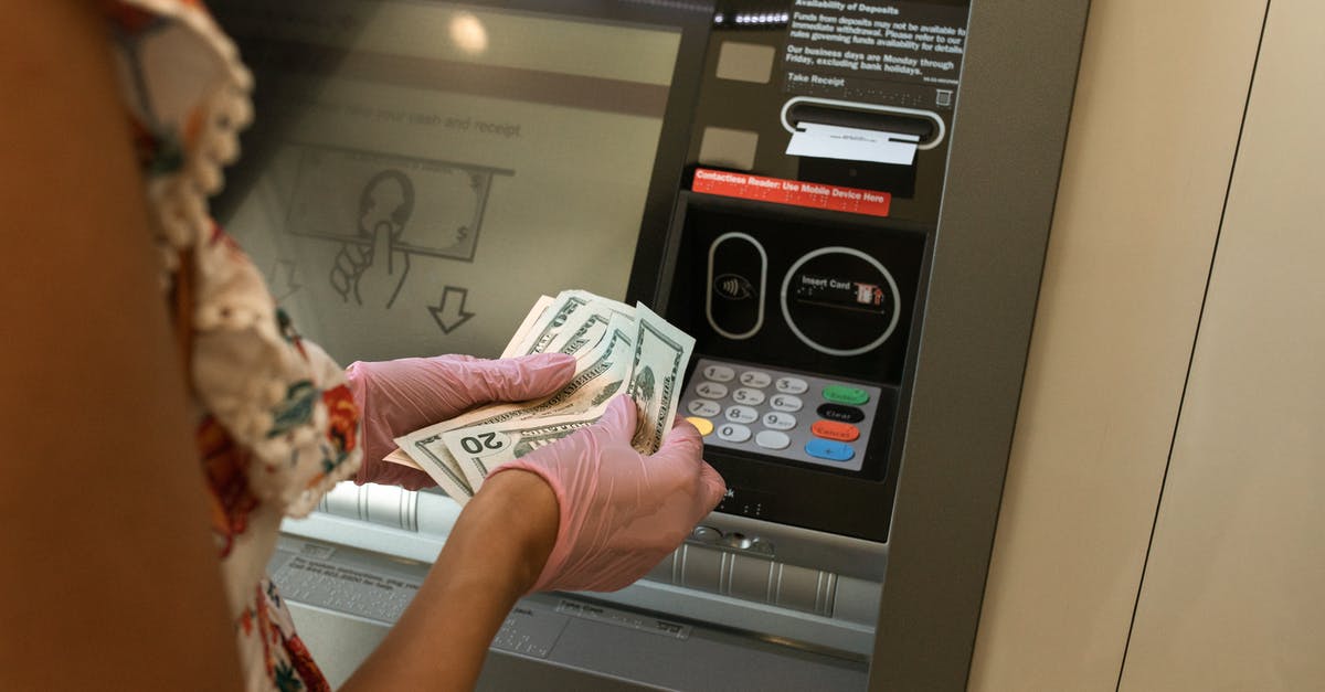 How to draw cash when ATM does not accept card? - Person Counting Money in front of ATM How to draw cash when ATM does not accept card? - Person Counting Money in front of ATM