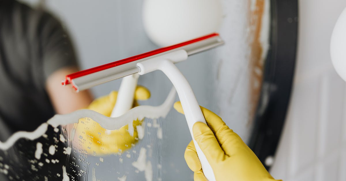 How to dry shirts using laundromats? - Anonymous person drying mirror with squeegee How to dry shirts using laundromats? - Anonymous person drying mirror with squeegee