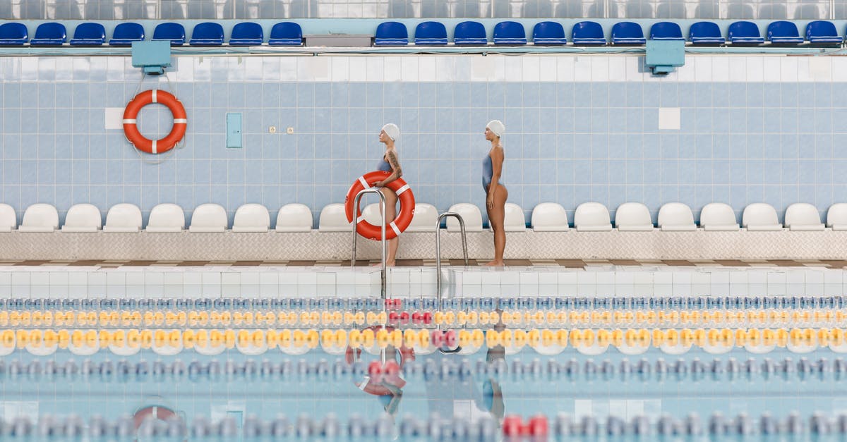 How to find airline seats with separate recline and back support controls? - Women Standing by the Poolside Holding a Lifesaver