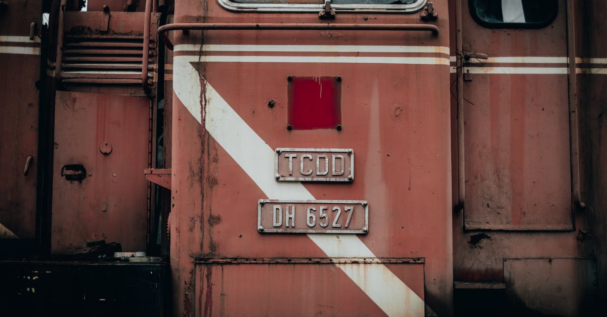 How to find out train track number in Spain? - Wagon of industrial red old timer metal train with plate and window near door located on street in railway station How to find out train track number in Spain? - Wagon of industrial red old timer metal train with plate and window near door located on street in railway station