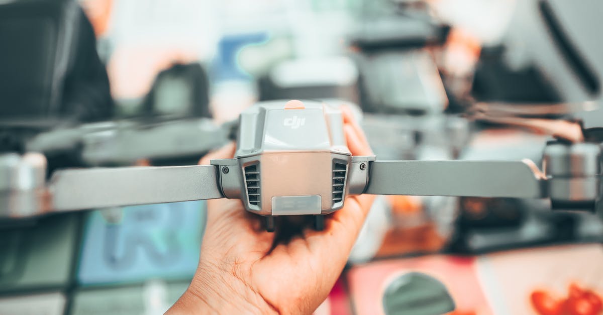 How to get a licence to fly a drone in the city of Prague for a week? [closed] - From above of crop faceless man examining professional UAV in apartment in city in soft daylight