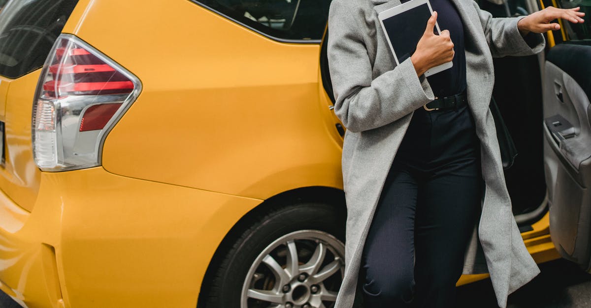 How to get a taxi on Prague streets? - Crop ethnic woman getting out of car How to get a taxi on Prague streets? - Crop ethnic woman getting out of car