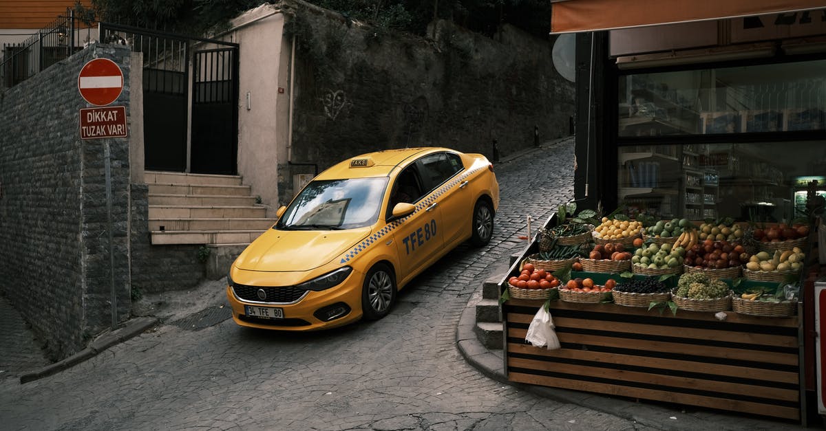 How to get a taxi on Prague streets? - Yellow Car Parked Beside Brown Wooden Bench How to get a taxi on Prague streets? - Yellow Car Parked Beside Brown Wooden Bench