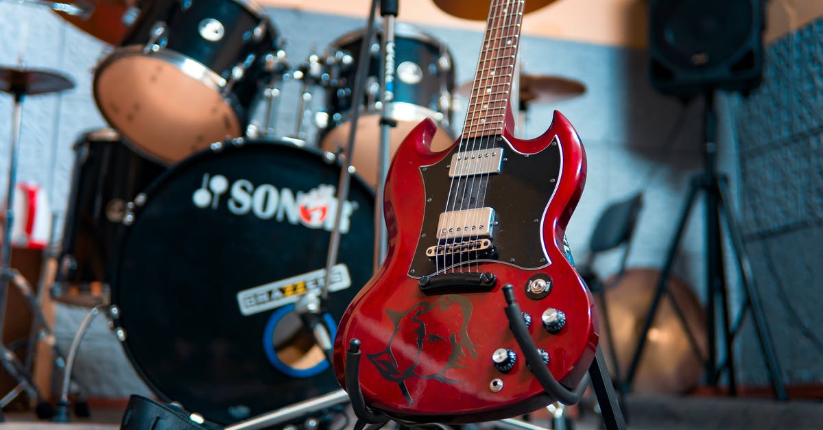 How to get an itinerary from a record locator - From below of modern electronic shiny guitar against drum kit and speakers in music studio
