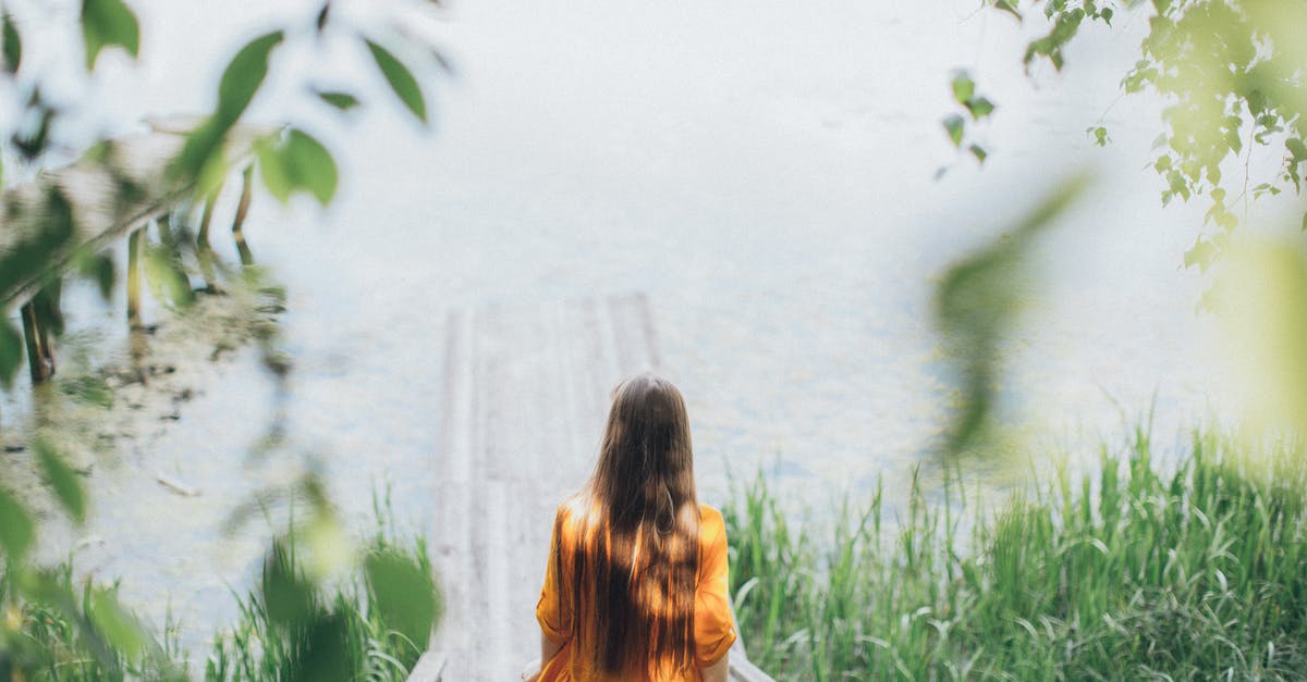 How to get back to Sathorn pier from Yaowarat? - Young woman walking down on wooden path towards lake