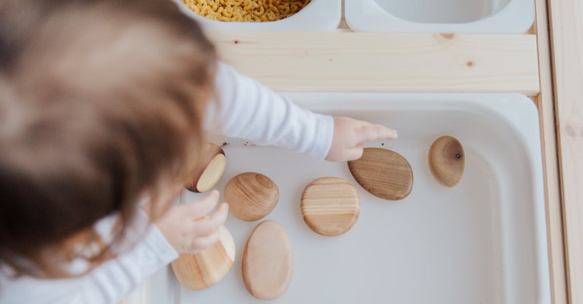 How to get from Bonifacio to Bastia via Calvi? - Crop anonymous child getting brown stones from white container at home How to get from Bonifacio to Bastia via Calvi? - Crop anonymous child getting brown stones from white container at home