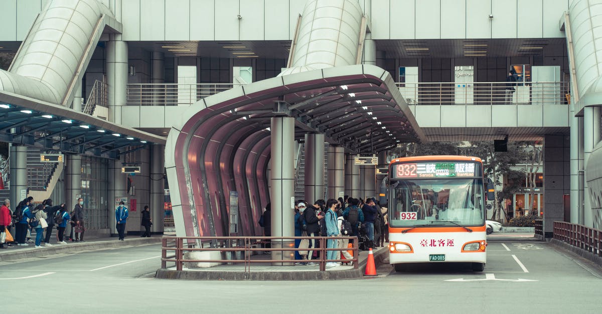 How to get from Heathrow Central Bus Station to Terminal 4 early in the morning? - People Standing at a Bus Station How to get from Heathrow Central Bus Station to Terminal 4 early in the morning? - People Standing at a Bus Station